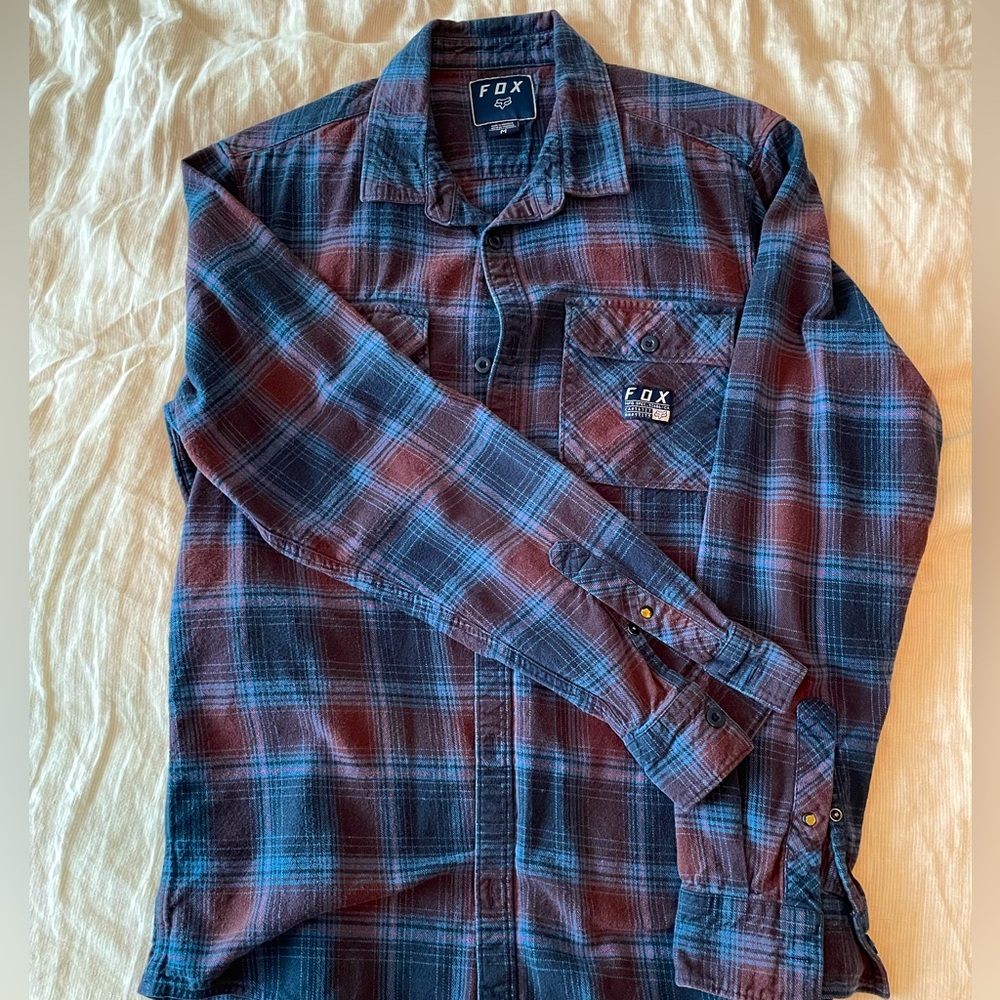 Men’s medium Fox Racing flannel in navy, brick, and sky-blue.
